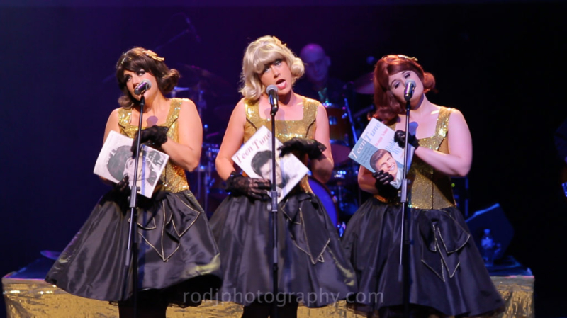 Girls in gold & black dresses with 60s magazines.