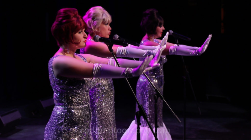 Girls in long silver gowns singing "Stop"